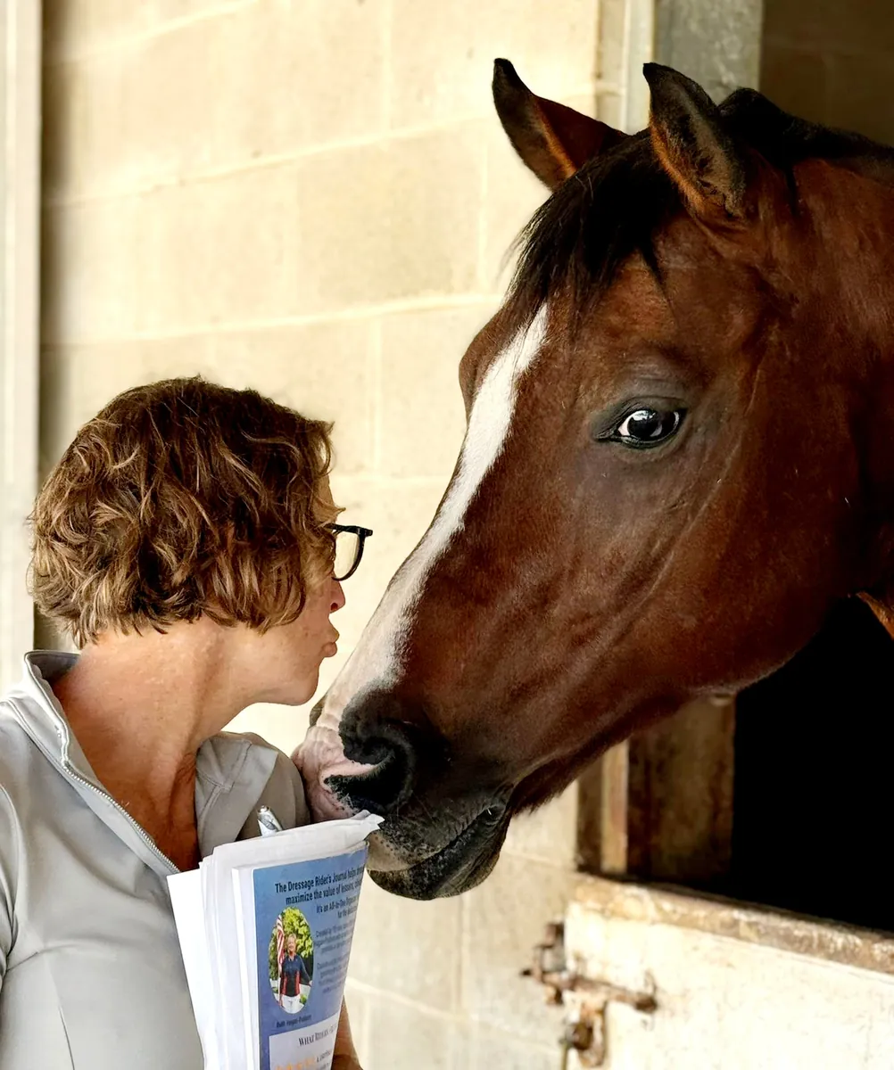 Barb with Rocket Star, holding the paper journal that started it all